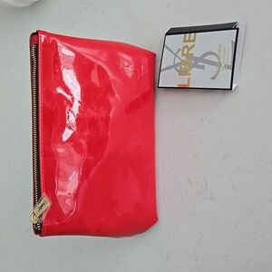 New cherry red patent YSL Yves Saint Laurent zipper clutch bag . Black interior
